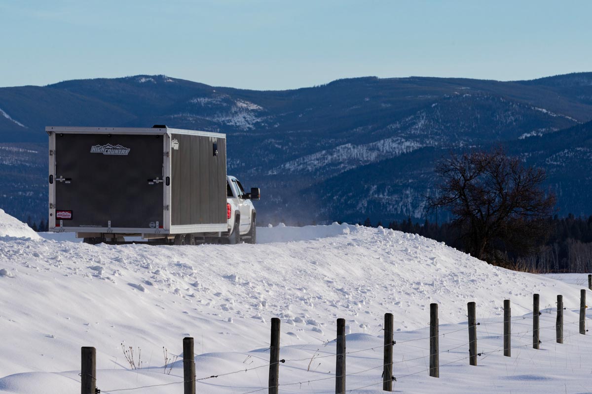 Enclosed Deckover 101" Wide Snow Grey Trailer On Windy Road