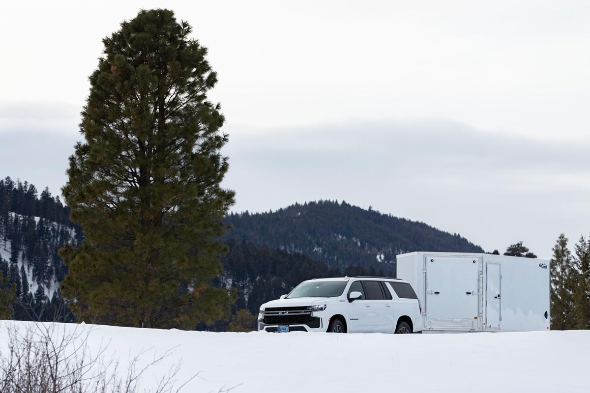 High Country Enclosed Deckover Lite Snow Trailer Driving Down Road