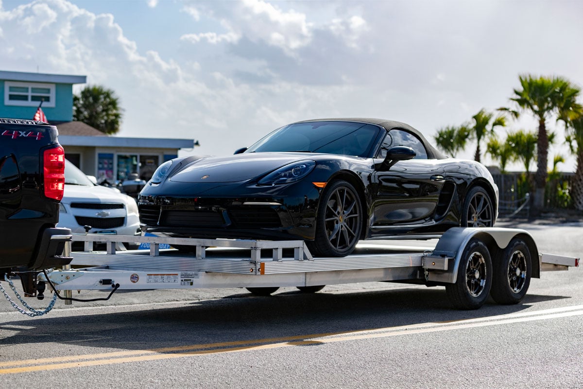 Open High Country Car Hauler Trailer With Black Porsche Loaded